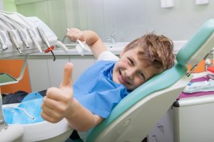 Kid smiling in dental chair